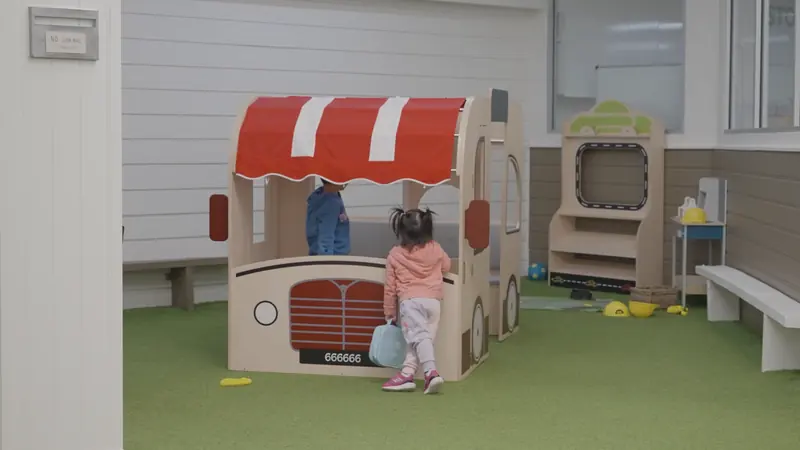 A toddler at the pretend food truck